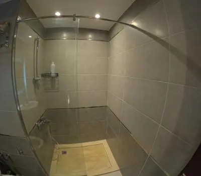 a shower with a glass door in a bathroom at Alhambara compound in Hurghada