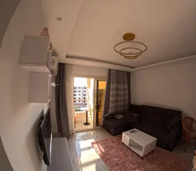 a living room with a couch and a table at Alhambara compound in Hurghada