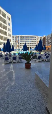 a group of chairs and tables with blue umbrellas at Tiba Golden Sand Dune Hurghada in Hurghada