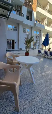 a white table and chairs in a building at Tiba Golden Sand Dune Hurghada in Hurghada