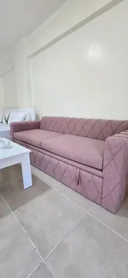 a purple couch in a living room with a table at Tiba Golden Sand Dune Hurghada in Hurghada