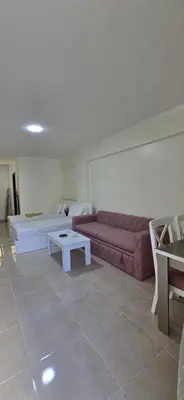 a living room with a couch and a table at Tiba Golden Sand Dune Hurghada in Hurghada