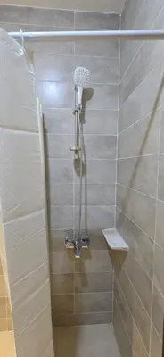 a shower with a shower head in a bathroom at Tiba Golden Sand Dune Hurghada in Hurghada