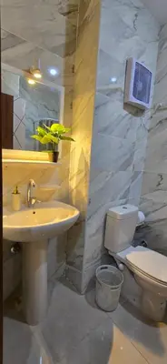 a bathroom with a sink and a toilet and a mirror at Tiba Golden Crystal Water Hurghada in Hurghada