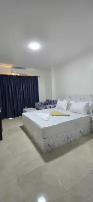 a bedroom with a large bed in a room at Tiba Golden Blue Coral Hurghada in Hurghada