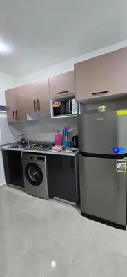 a kitchen with a stove and a dishwasher at Tiba Golden Blue Coral Hurghada in Hurghada