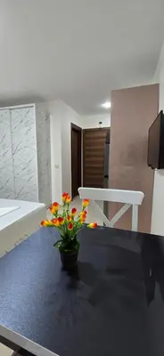 a room with a table with a vase with flowers on it at Tiba Golden Blue Coral Hurghada in Hurghada