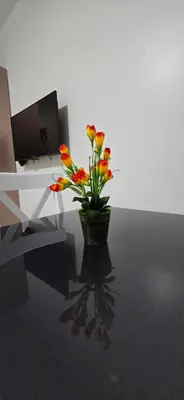 a vase with flowers sitting on a table at Tiba Golden Blue Coral Hurghada in Hurghada