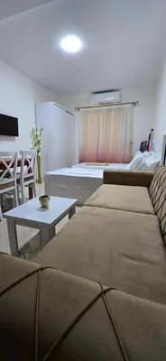 a living room with a couch and a bed and a table at Tiba Golden Crystal Oasis Hurghada in Hurghada