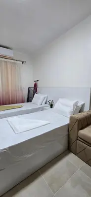 two large beds in a bedroom with a couch at Tiba Golden Crystal Oasis Hurghada in Hurghada