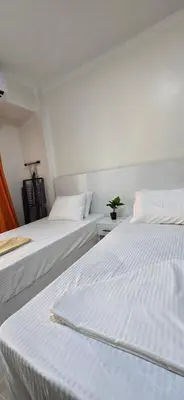 two beds sitting next to each other in a room at Tiba Golden Golden Coast Hurghada in Hurghada