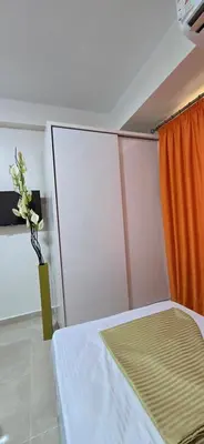 a bedroom with a bed and a vase of flowers at Tiba Golden Golden Coast Hurghada in Hurghada