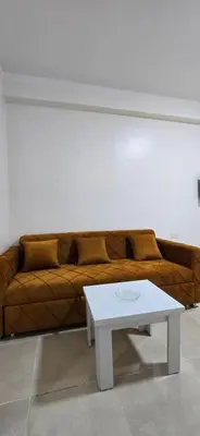 a couch with a white coffee table in a room at Tiba Golden Golden Coast Hurghada in Hurghada