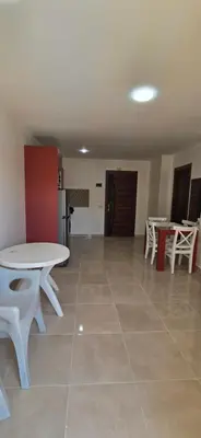 a room with a table and chairs and a kitchen at Tiba Golden Serenity Hurghada in Hurghada
