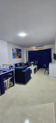 a living room with a couch and a table at Tiba Golden Sun and Sea Hurghada in Hurghada