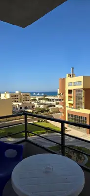 a balcony with a table and a view of a city at Tiba Golden Sun and Sea Hurghada in Hurghada