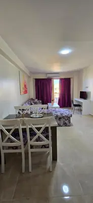 a living room with a table and a bed at Tiba Golden Sand Palace Hurghada in Hurghada