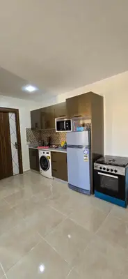 an empty kitchen with a stove and a refrigerator at Tiba Golden Sand Palace Hurghada in Hurghada