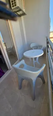 a table and two chairs and a table and a table at Tiba Golden Sand Palace Hurghada in Hurghada