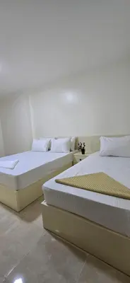 two beds sitting next to each other in a room at Tiba Golden Amber Sands Hurghada in Hurghada
