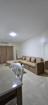 a living room with a couch and a table at Tiba Golden Amber Sands Hurghada in Hurghada