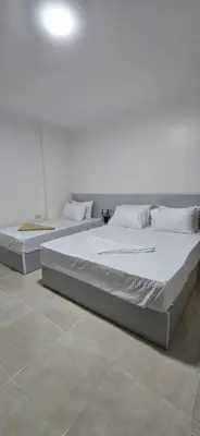 two beds sitting in a room with at Tiba Golden Oasis Royale Hurghada in Hurghada