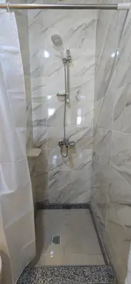 a bathroom with a shower with a glass door at Tiba Golden Oasis Royale Hurghada in Hurghada