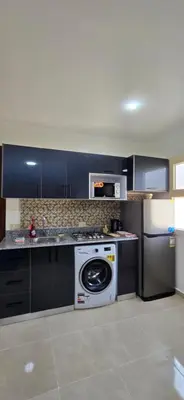 a kitchen with a washing machine and a dishwasher at Tiba Golden Oasis Royale Hurghada in Hurghada