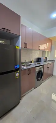 a kitchen with a refrigerator and a washing machine at Tiba Golden Blue Mirage Hurghada in Hurghada