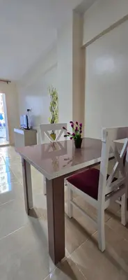 a dining room table with two chairs and flowers on it at Tiba Golden Blue Mirage Hurghada in Hurghada