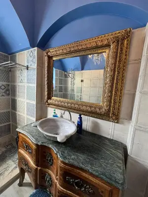 a bathroom with a large mirror and a sink at El Gouna 4 Bedroom 4 Bathroom Lagoon villa in Banī Ghālib