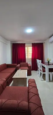a living room with a couch and a table at Tiba Golden Sea Beiss Hurghada in Hurghada