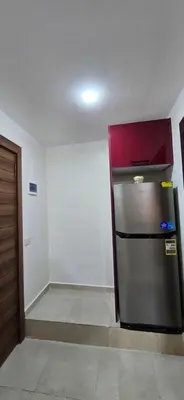 a kitchen with a stainless steel refrigerator in a room at Tiba Golden Sea Beiss Hurghada in Hurghada