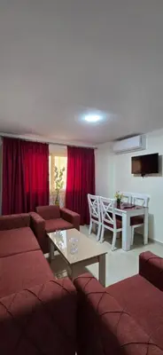 a living room with couches and a table and a dining room at Tiba Golden Sea Beiss Hurghada in Hurghada
