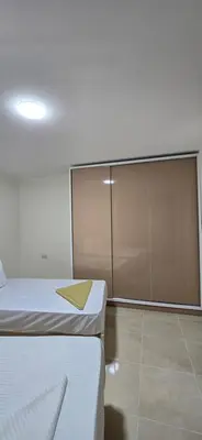 a room with two beds and a sliding glass door at Tiba Golden Sea Beiss Hurghada in Hurghada