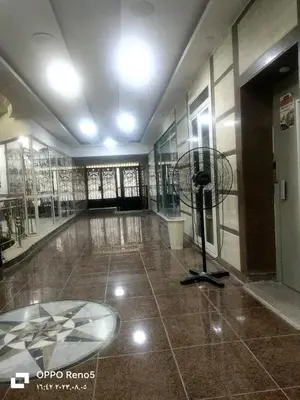 a room with a fan in the middle of a building at شقه فاخره مجهزه بالكامل مكيفه مع ثلاث غرف في وسط الاقصر in Luxor