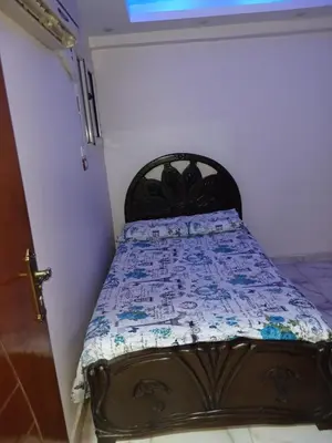 a bed with a quilt on it in a room at شقه فاخره مجهزه بالكامل مكيفه مع ثلاث غرف في وسط الاقصر in Luxor