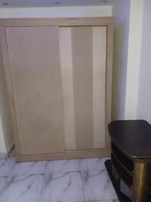 a sliding door in a room with a table at شقه فاخره مجهزه بالكامل مكيفه مع ثلاث غرف في وسط الاقصر in Luxor