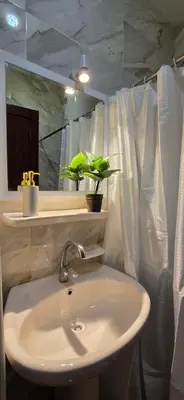 a white bathroom with a sink and a mirror at Tiba Golden Oasis Mirage Hurghada in Hurghada
