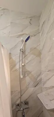 a shower with a shower head in a bathroom at Tiba Golden Oasis Mirage Hurghada in Hurghada