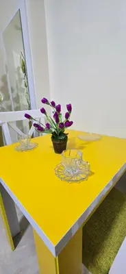 a yellow table with flowers on top of it at Tiba Golden Oasis Mirage Hurghada in Hurghada
