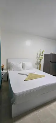 a white bed with a gold napkin on it at Tiba Golden Palm Hurghada in Hurghada