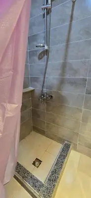 a shower in a bathroom with a tile floor at Tiba Golden Crystal Lagoon Hurghada in Hurghada