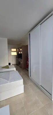 a bedroom with two beds and a sliding glass door at Tiba Golden Crystal Lagoon Hurghada in Hurghada