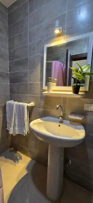 a bathroom with a sink and a mirror and towels at Tiba Golden Crystal Lagoon Hurghada in Hurghada