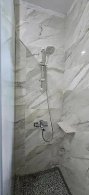 a shower with a shower head in a bathroom at Tiba Golden Sun flare Hurghada in Hurghada