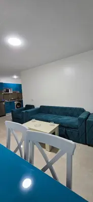 a living room with a blue couch and a table at Tiba Golden Sun flare Hurghada in Hurghada