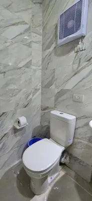 a bathroom with a toilet and a air conditioner at Tiba Golden Sun flare Hurghada in Hurghada