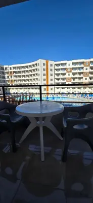 a table and chairs in front of a building at Tiba Golden Azure Coast Hurghada in Hurghada