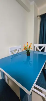 a blue table with a vase with flowers on it at Tiba Golden Azure Coast Hurghada in Hurghada